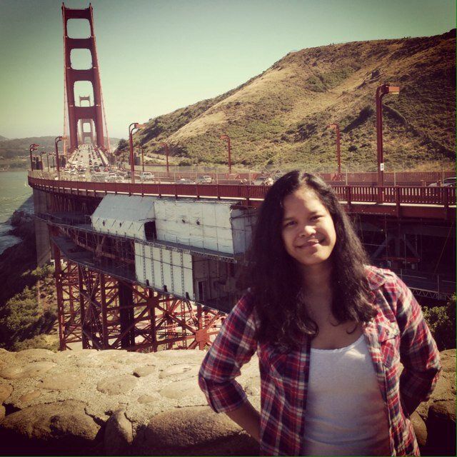 Jade Grout, in plaid shirt, standing on the marin headlands side of the golden gate bridge